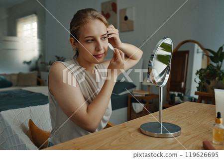 Applying Makeup and Sitting by Vanity in Cozy Bedroom 119626695