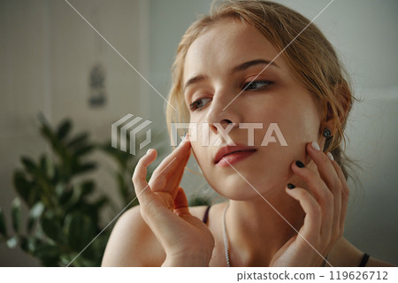 Women Touching Her Face Looking Contemplative Women Touching Her Face Looking Contemplative 119626712