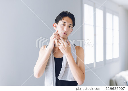 Young man looking in the mirror Young man looking in the mirror 119626907
