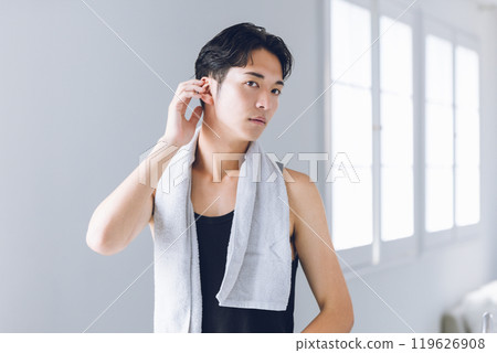 Young man looking in the mirror 119626908