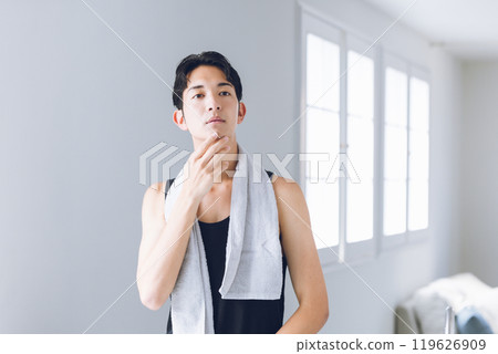 Young man looking in the mirror 119626909