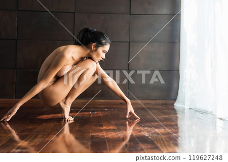 Portrait of Asian sexy woman exercise yoga on wood floor Portrait of Asian sexy woman exercise yoga on wood floor 119627248