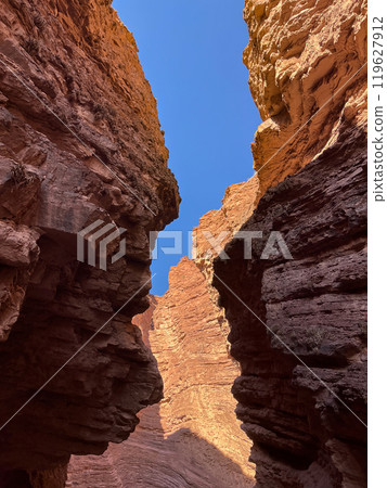 Faces of aboriginal people in the rock formations of Salta, Arg. 119627912
