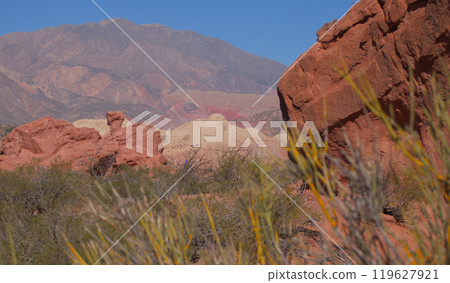 Beautiful scene with rock formations and colourful mountains in the background. 119627921