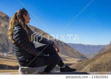 Tourist looking at a mountain landscape in northern Argentina. 119628062