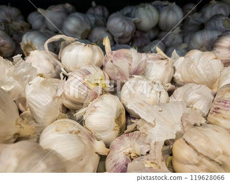 Garlic background. Garlic is on the counter in the store. Garlic is near 119628066