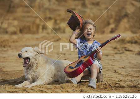 Funny child in a cowboy costume with a dog Funny child in a cowboy costume with a dog 119628126