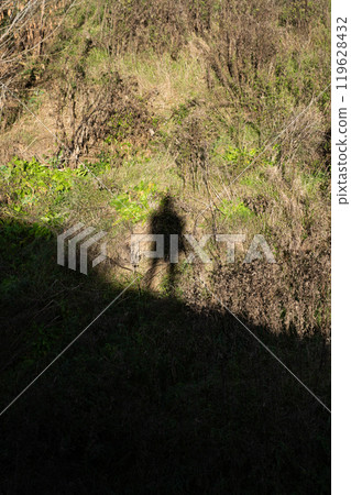 The shadow of a man in the distance looking down. The shadow of a man at the top The shadow of a man in the distance looking down. The shadow of a man at the top 119628432