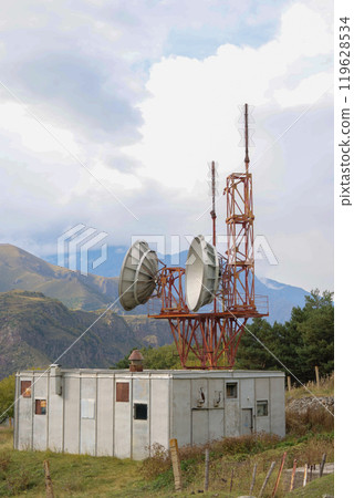 Telecommunications satellite dish radio telescope in mountains. Earth based astronomical locator Telecommunications satellite dish radio telescope in mountains. Earth based astronomical locator 119628534