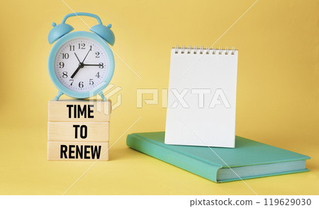 It's time to update the word written on the wooden blocks. On a yellow background there is a clock It's time to update the word written on the wooden blocks. On a yellow background there is a clock 119629030