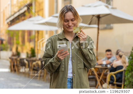 Woman using credit bank card and smartphone while transferring money, purchases online shopping 119629307