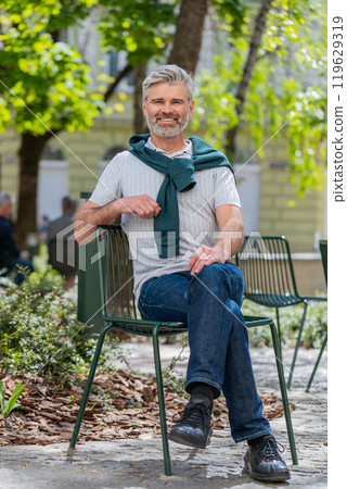 Portrait of happy bearded mature man smiling friendly, glad expression looking at camera relaxation Portrait of happy bearded mature man smiling friendly, glad expression looking at camera relaxation 119629319