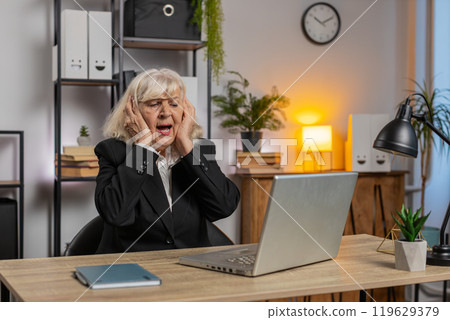 Elderly employer freelancer using laptop working at home office having nervous breakdown at work 119629379
