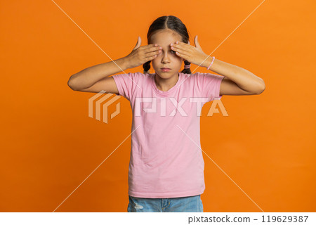 Afraid shocked child girl closing eyes, confused shy scared reject to watch, phobia, shame, stress 119629387