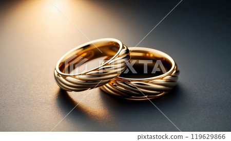 a pair of gold wedding rings 119629866