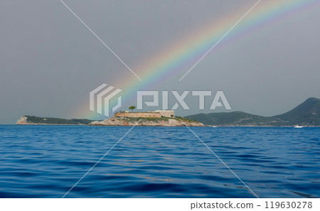 Rainbow over an island with an ancient fortress-prison in the Mediterranean Sea Rainbow over an island with an ancient fortress-prison in the Mediterranean Sea 119630278
