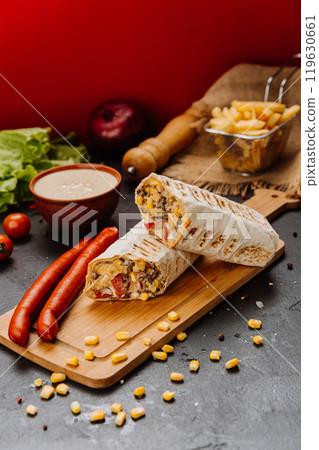 Grilled wrap filled with sausage, corn, and melted cheese. Hearty meal or street food craving Grilled wrap filled with sausage, corn, and melted cheese. Hearty meal or street food craving 119630661