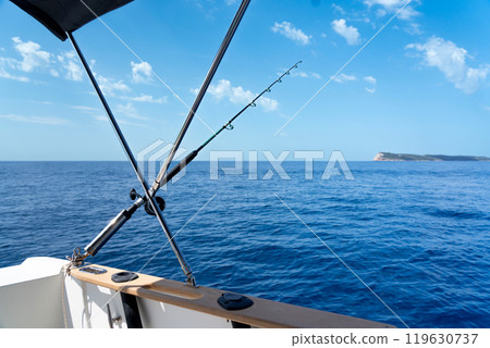 Spinning rod fixed on board a boat during sea fishing Spinning rod fixed on board a boat during sea fishing 119630737