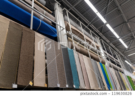 Large assortment of carpets for sale in a store. Large assortment of carpets for sale in a store. 119630826