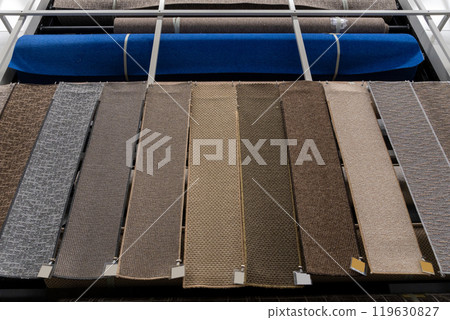 Large assortment of carpets for sale in a store. Large assortment of carpets for sale in a store. 119630827