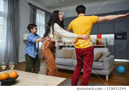Family enjoying a playful moment in a modern living room together Family enjoying a playful moment in a modern living room together 119631244