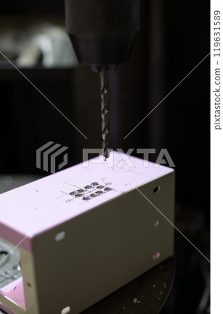 Drilling holes in the control box using a drill press 119631589