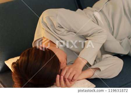Woman feeling unwell at night Woman feeling unwell at night 119631872