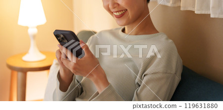 A woman watching a night smartphone 119631880