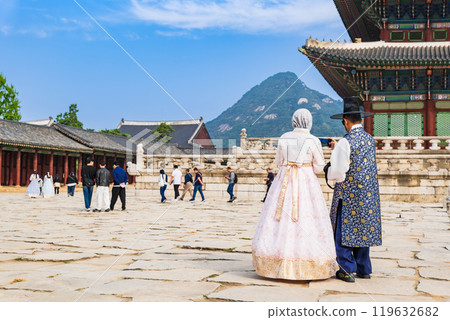 Tourists taking photos in traditional Korean clothing at Gyeongbokgung Palace in Seoul 119632682