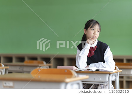 Japanese female junior high school student gets bored during class Japanese female junior high school student gets bored during class 119632910