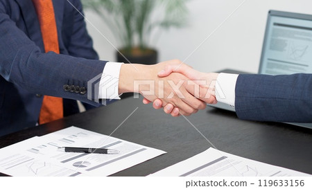 Businessmen shaking hands at a meeting Businessmen shaking hands at a meeting 119633156