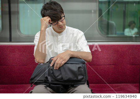 A worried man riding a train 119634940