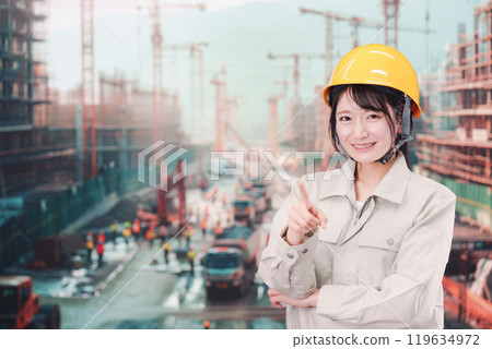 Young woman working on a large construction site Young woman working on a large construction site 119634972