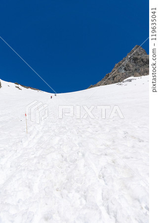 Climbing Mount Yari in the early summer with snow remaining in the mountains of the Northern Alps - Mount Yari and the mountain lodge 119635041