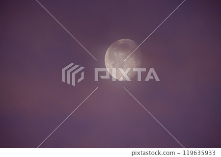 A Gorgeous Moon Shines Beautifully Amidst Wispy Clouds at Dusk, Creating a Dreamy Atmosphere A Gorgeous Moon Shines Beautifully Amidst Wispy Clouds at Dusk, Creating a Dreamy Atmosphere 119635933