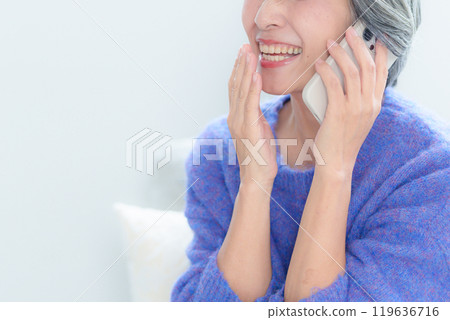 Middle-aged woman talking on smartphone 119636716