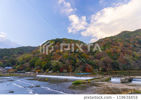Around Togetsukyo Bridge in Arashiyama in autumn. The autumn foliage of the mountains can be seen in the background. Around Togetsukyo Bridge in Arashiyama in autumn. The autumn foliage of the mountains can be seen in the background. 119638858