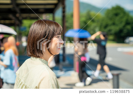 A woman stopping at a service area to take a break while driving A woman stopping at a service area to take a break while driving 119638875