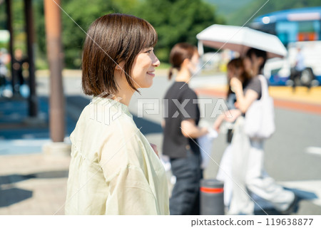 A woman stopping at a service area to take a break while driving 119638877