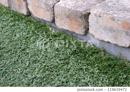 Bricks and artificial grass Bricks and artificial grass 119639472