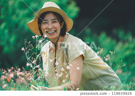 A woman picking saponaria in a flower field 119639926