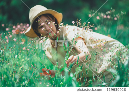 A woman picking saponaria in a flower field 119639928