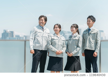 Male and female staff in the manufacturing, building, transportation, and construction industries wearing work clothes. 119640430