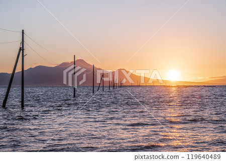 Nagabeda Seaside Road and the sunset over Mount Unzen Fugen 119640489