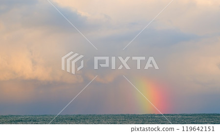Delicate Rainbow Over The Ocean. Beautiful Rainbow Over The Stormy Sea Waters. Static view. Delicate Rainbow Over The Ocean. Beautiful Rainbow Over The Stormy Sea Waters. Static view. 119642151