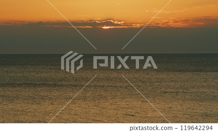 Color Of Sunlight In Sky Reflecting In Sea Water. Orange And Red Tones Reflects In Ocean. Still. 119642294