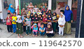 group of happy elementary pupils reading 119642570