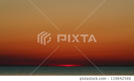 Sun Sets Turning Sky Yellow And Orange With Red. Sun Reflecting On Sparkling Sea Water Surface. Slow motion. 119642588