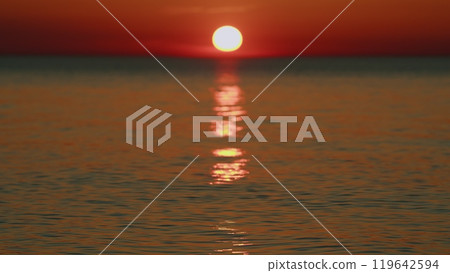 Golden Glare On Water Abstract Background. Sunset At Sea. Ocean Colors Sky And Waves In Red Color. Slow motion. 119642594