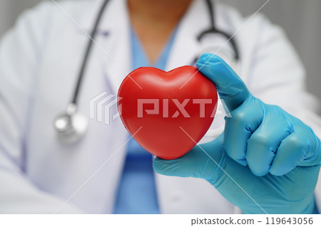Asian woman doctor holding red heart for health in hospital. Asian woman doctor holding red heart for health in hospital. 119643056